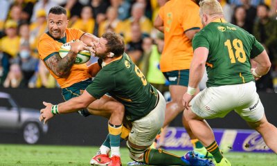 Quade Cooper is tackled be Duane Vermeulen