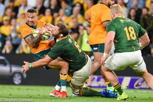 Quade Cooper is tackled be Duane Vermeulen